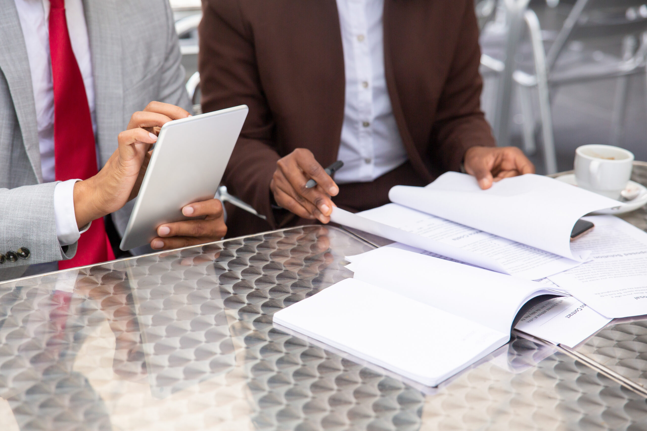 cropped shot of two businesspeople working with documents